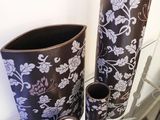 three vases sitting on a glass table next to each other