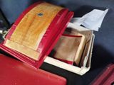 a red suitcase with a wooden box inside of it