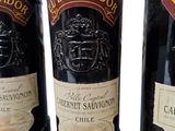 three bottles of wine sitting on top of a table next to each other