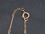 a close up of a gold chain with a clasp on it