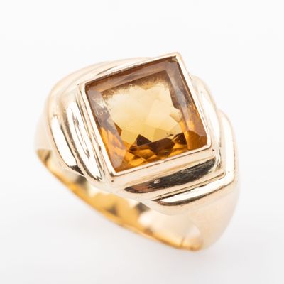 an image of a gold ring with a citrine stone in the center