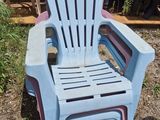 a plastic chair that is sitting in the grass