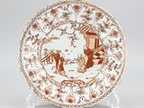 a brown and white plate with a picture of people on it