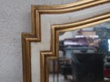 a mirror that is hanging on a wall in a room
