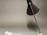 a black lamp that is on top of a metal pole