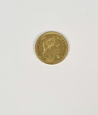 a close up of a gold coin on a white surface