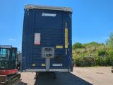 a blue trailer that is parked in a lot