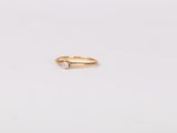 a gold ring with a single diamond on top of it