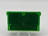 a close up of a green electronic device on a white surface