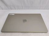 an apple macbook air laptop computer sitting on top of a bed