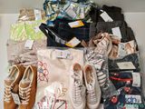 Plusieurs paires de chaussures et un sac de vêtements sont posés sur une étagère