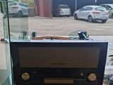 a radio that is sitting on a table in front of a window
