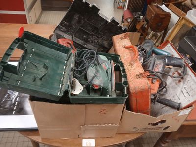 a pile of tools sitting on top of a wooden table