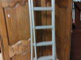 a ladder leaning against a cabinet in a room