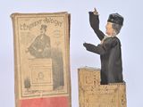 figurine of a man giving a speech in front of a box