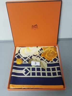 an orange box with a blue and white scarf in it