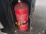 a red fire extinguisor in the back of a truck