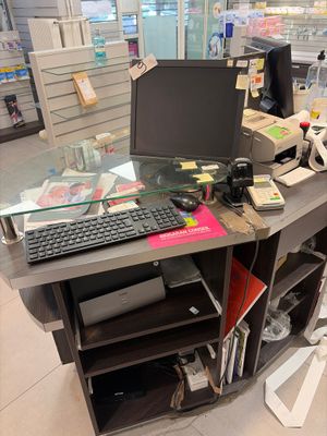 a computer desk with a keyboard and a monitor on it