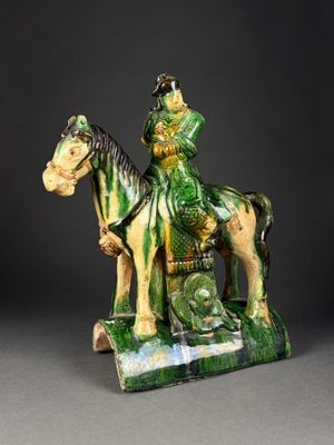 figurine of a man on a horse with a dragon on the back