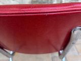 an image of a red leather chair on a tile floor