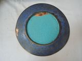 a blue plate with a gold rim on a white table