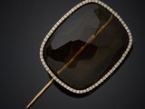 a black diamond and gold broochet broochle
