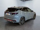 the rear end of a grey car in a showroom