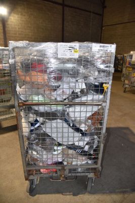 a metal cart with many items in it in a warehouse