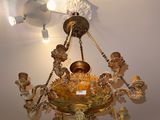 a chandelier with a bird nest hanging from it ' s ceiling