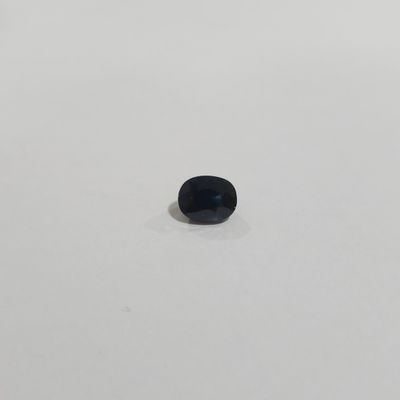 an image of a small black stone on a white surface