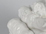 a close up of a white elephant statue on a table