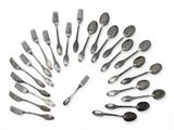 a lot of silver spoons and forks arranged in a circle