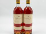 deux bouteilles de vin posées l'une à côté de l'autre sur une surface blanche