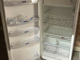 a small refrigerator with its door open on the floor