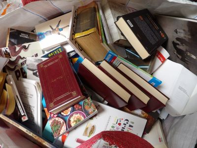 many books in a box on the floor
