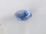 a very large blue stone on a white surface