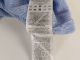 a blue teddy bear with a label on it ' s arm