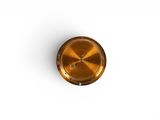 an overhead view of a brass knob on a white background