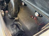 a car trunk with a helmet and other items in it
