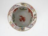 a small bowl with a fish design on it