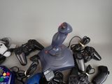 a pile of video game controllers and controllers on a table