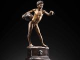 an image of a bronze statue of a man on a pedestal