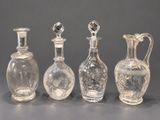 three clear glass vases sitting next to each other on top of a table