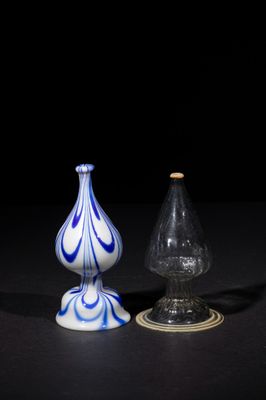 two glass vases sitting on top of a table next to each other