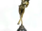bronze statue of a woman on a pedestal with her arms outstretched