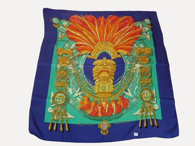 blue silk scarf with a gold and red design on it