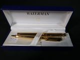 two pens in a blue box on a black surface