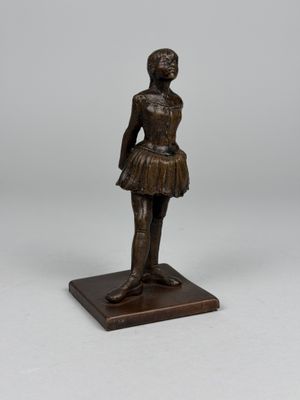 a bronze statue of a woman in a tutu