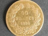a close up of a gold coin on a black surface