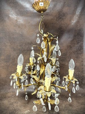 a gold chandelier with crystal drops hanging from it